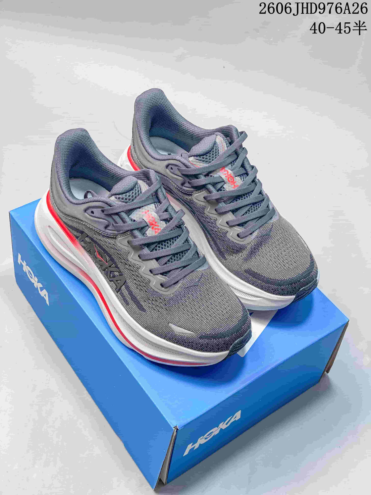 Pair of gray HOKA Bondi 9 shoes with white midsoles and red accents on a blue shoe box