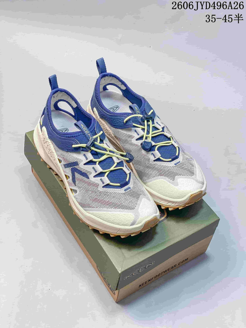 Pair of Keen Zionic ADV hiking shoes in white, blue, and yellow