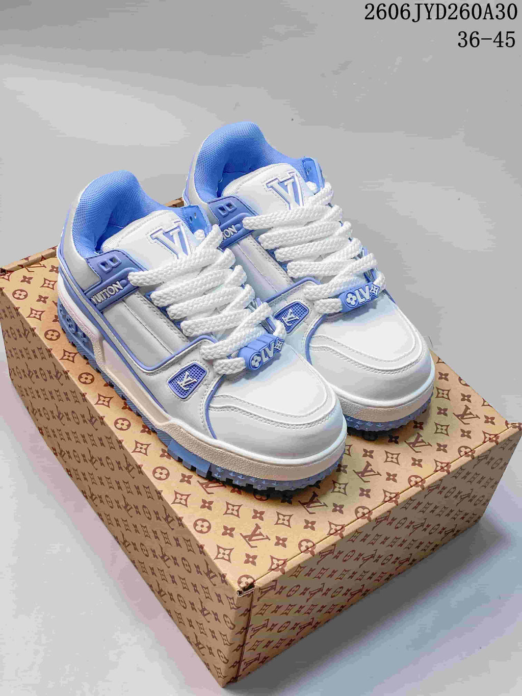 Pair of white and blue Louis Vuitton Trainer Maxi low-top sneakers with oversized laces