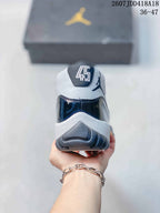 Rear view of the sneaker showing the padded collar, heel branding and dark navy heel panel.