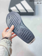 Close-up of the black outsole showing longitudinal grooves and a segmented traction pattern, with the listed range 36–45 visible above.