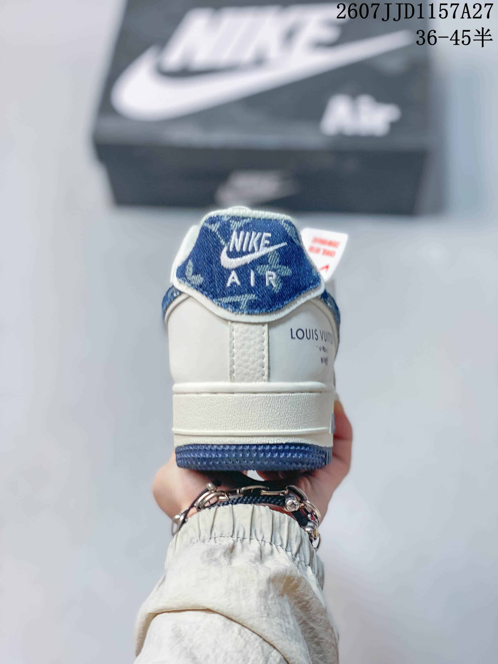 Rear view showing the white heel, blue trim, Nike Air tongue label, and decorative side branding.