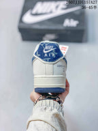 Rear view showing the white heel, blue trim, Nike Air tongue label, and decorative side branding.
