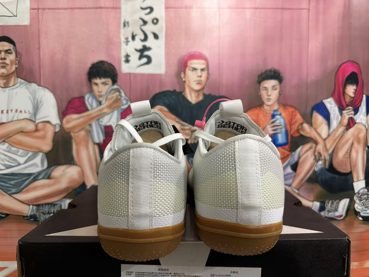 Rear view of white Converse Star Series sneakers with gum-colored outsoles