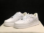 Three-quarter front view highlighting the white low-top profile, tonal star panels, perforated toes, and layered outsole.