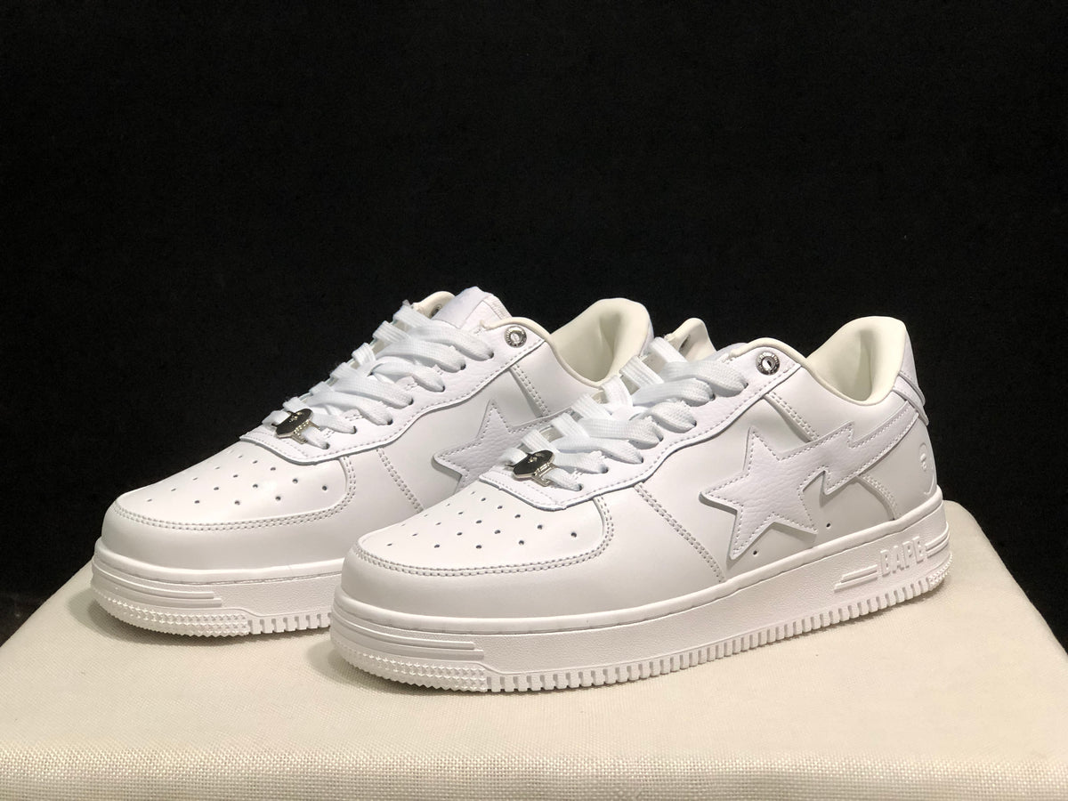 Three-quarter front view highlighting the white low-top profile, tonal star panels, perforated toes, and layered outsole.