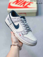 Angled side view highlighting the white and navy Swoosh, graphic side-panel accents, patterned laces, and low-top shape.