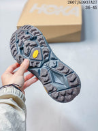 Close view of the sneaker outsole showing a gray lugged tread pattern and yellow sole branding.