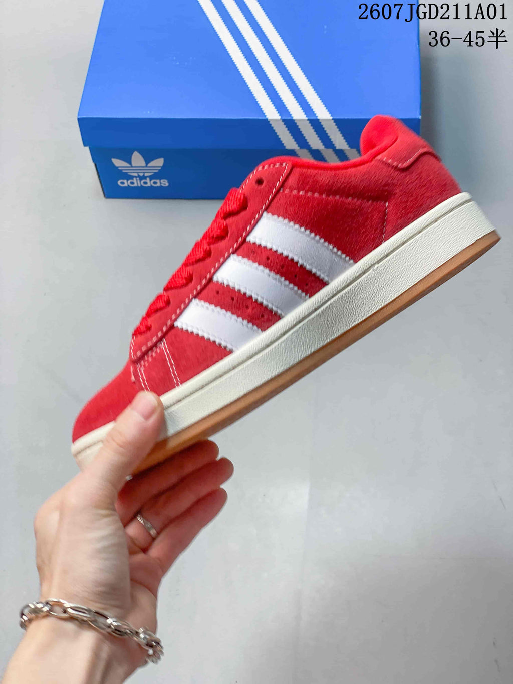 Side profile showing red upper, white stripes, and gum outsole