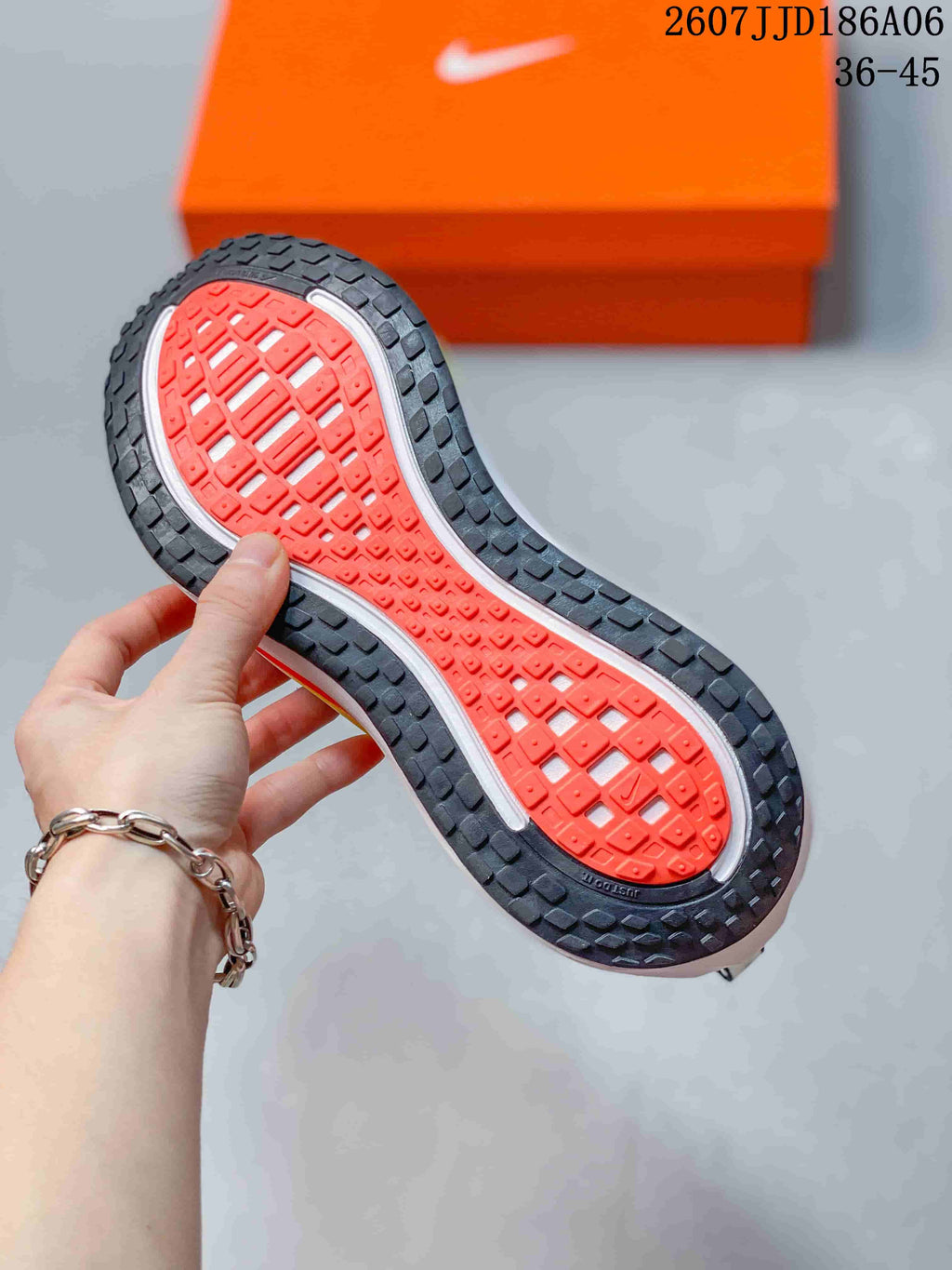 Underside view of a Nike running shoe showing the black and orange patterned outsole.