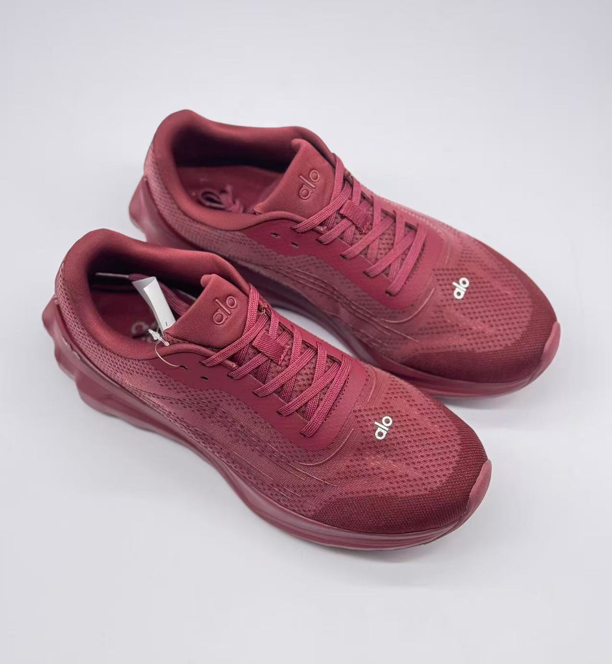Top three-quarter view of the burgundy lace-up sneaker pair.