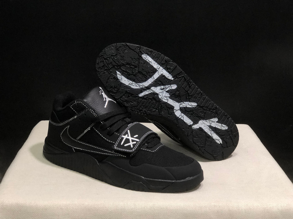 Black sneaker shown with the outsole facing upward, displaying the textured tread pattern and white graphics.