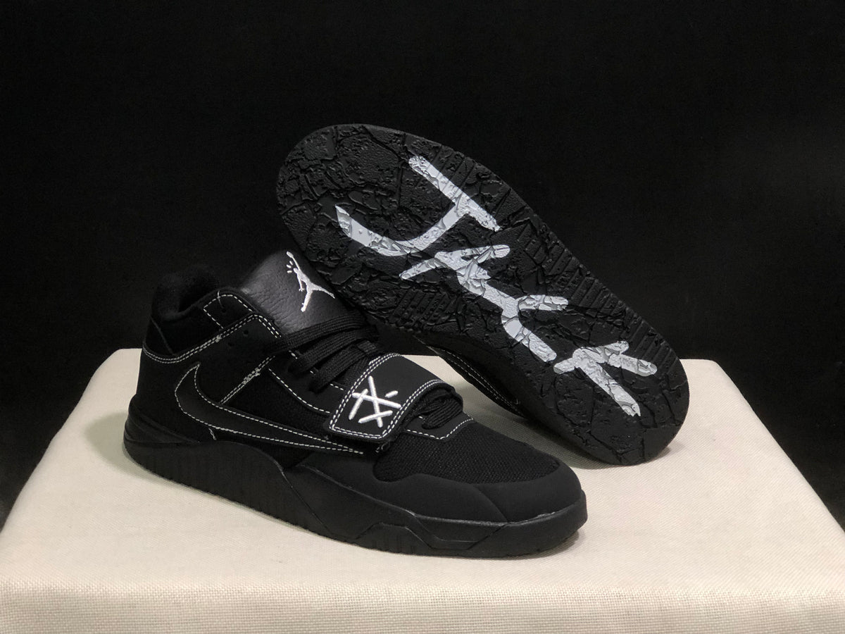 Black sneaker shown with the outsole facing upward, displaying the textured tread pattern and white graphics.