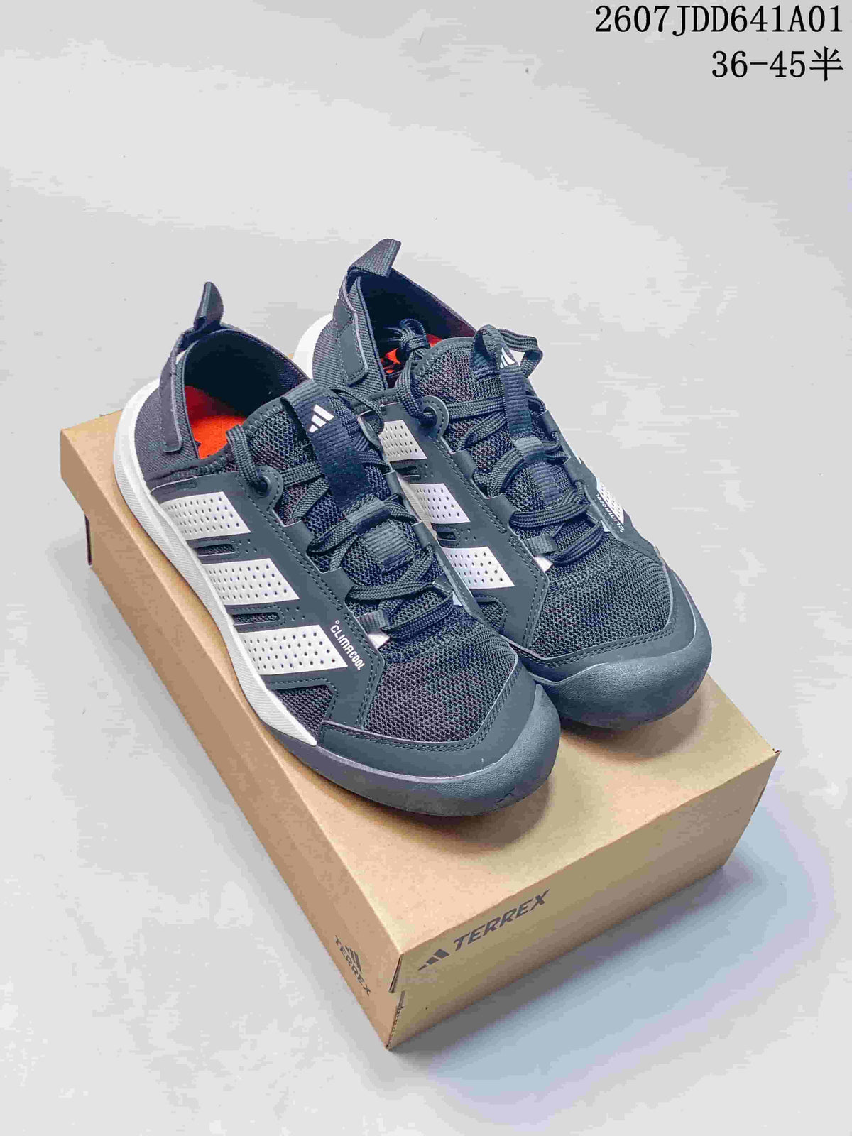 Pair of dark gray adidas Terrex Climacool sneakers with white side details shown on a shoebox