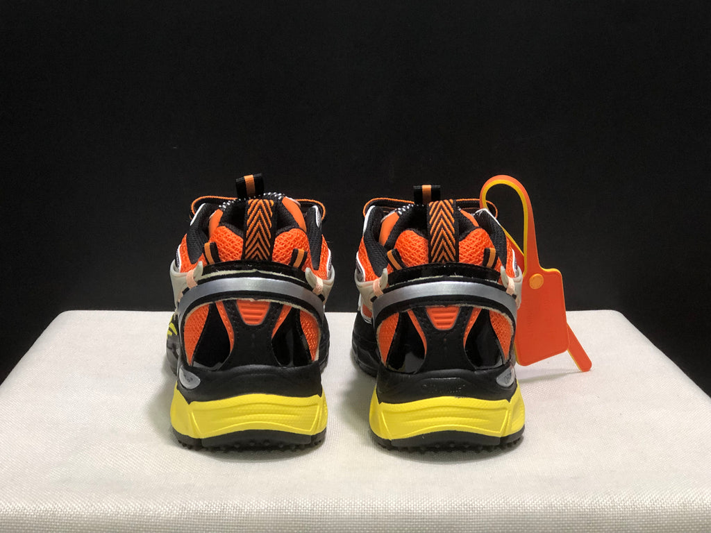 Rear view showing the padded collars, heel details, black sections, and yellow outsole.