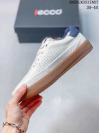 Side view of the white lace-up sneaker showing perforated panels, navy collar detail, and a gum-colored outsole; style code 2607GXD517A07 and size range 39-44 are visible.