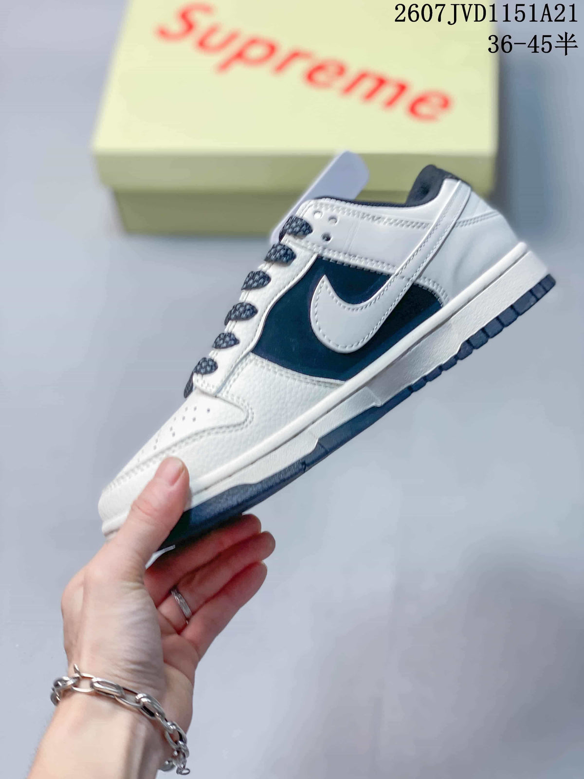 Side profile showing the white and navy panels, contrasting Swoosh and dark outsole.
