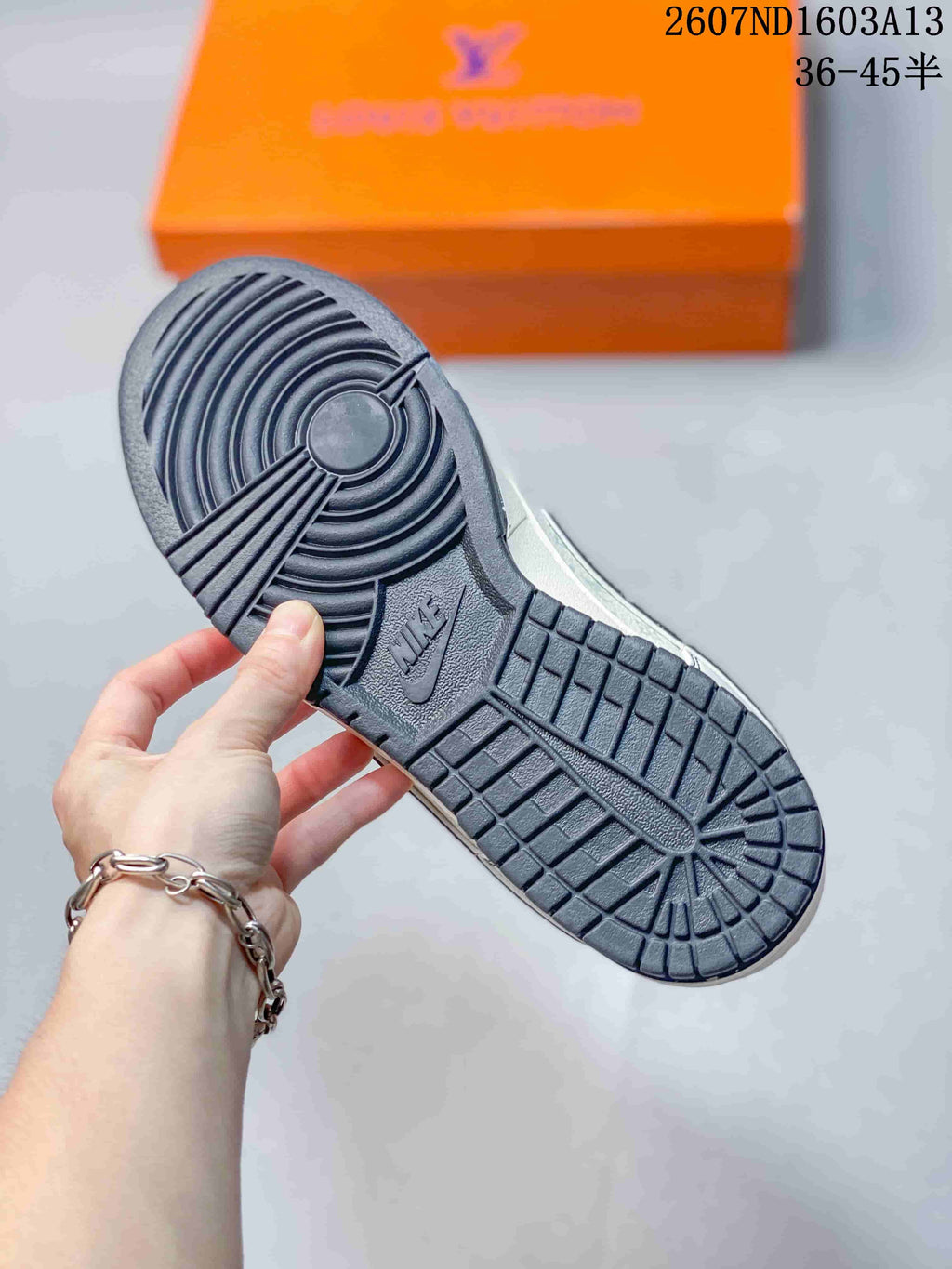 Close view of the dark rubber outsole showing circular and rectangular traction sections.