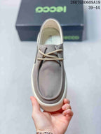 Top view of the gray sneaker showing the lace-up fastening, stitched toe panel, and insole branding.