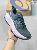 Angled side view showing the dark upper, ASICS branding, white midsole and black outsole.