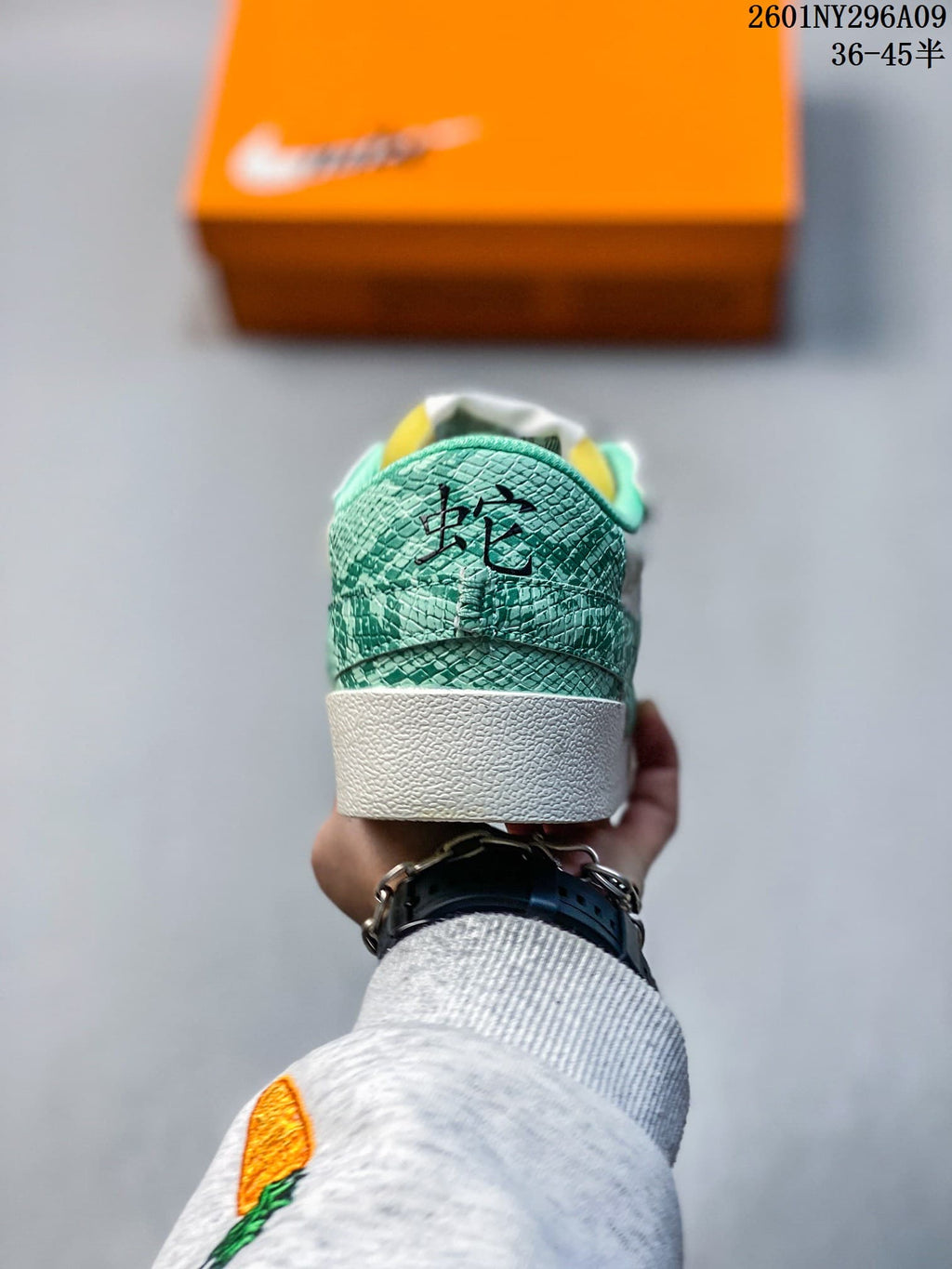 Rear view showing the green patterned heel panels and white midsole.