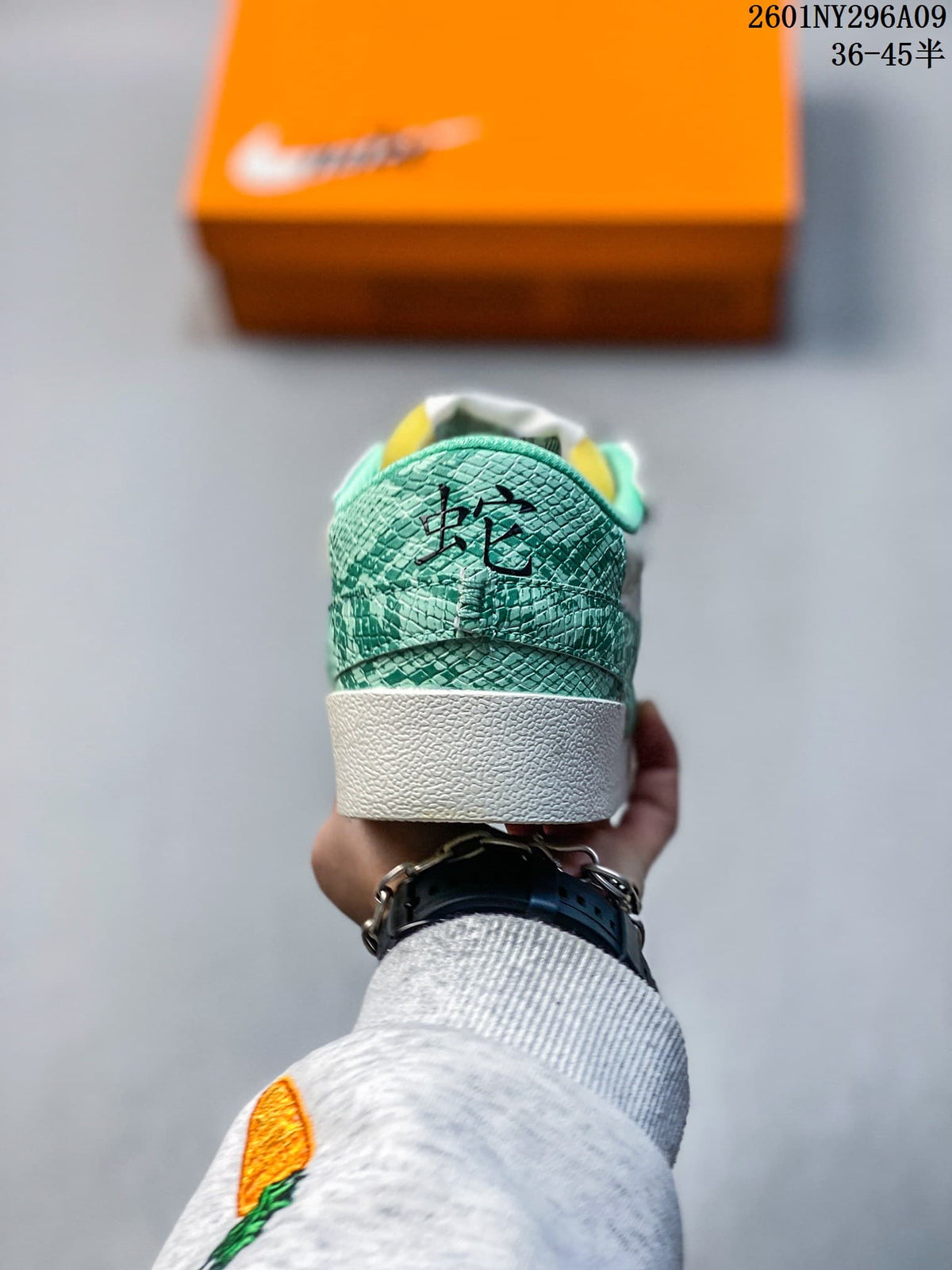 Rear view showing the green patterned heel panels and white midsole.