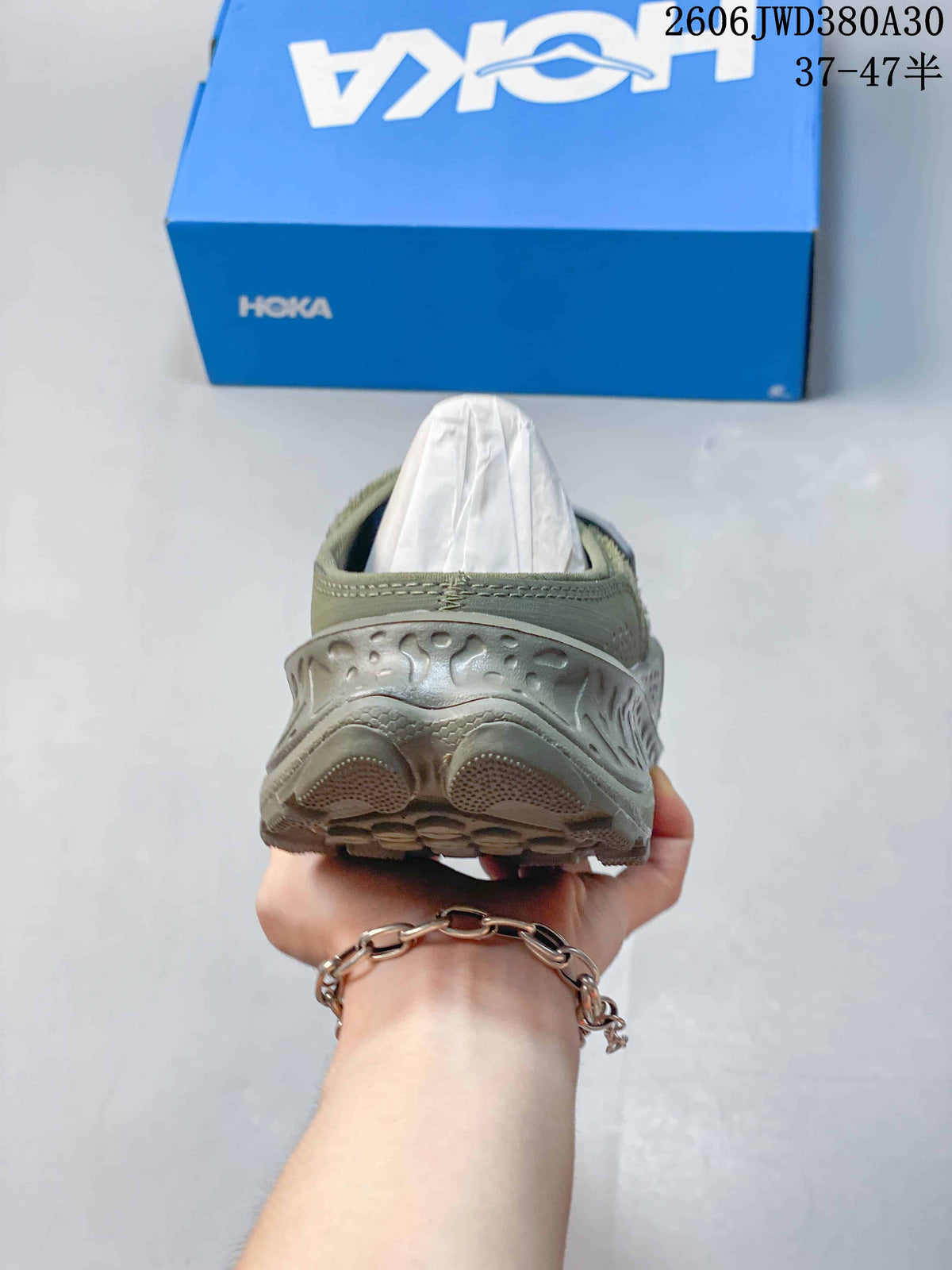 Rear view showing the sculpted heel and sole of the mule sneaker