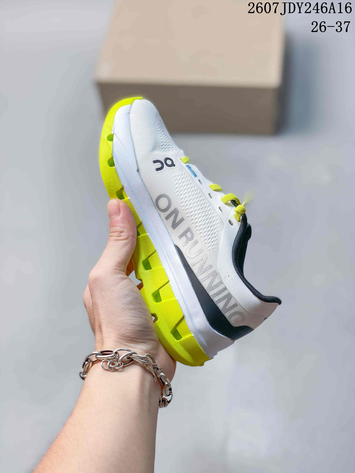 Side view of a white On shoe with large side branding, lime outsole elements, and lace-up closure.