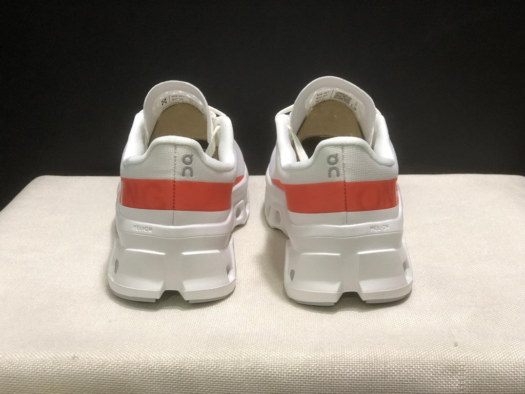Rear view of the pair showing the coral heel stripe and On branding.