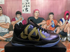 Side view of a black and metallic purple Nike basketball shoe with gold snake-inspired graphics