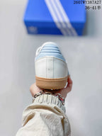 Rear view showing the white heel, light blue detailing, and gum-colored outsole.