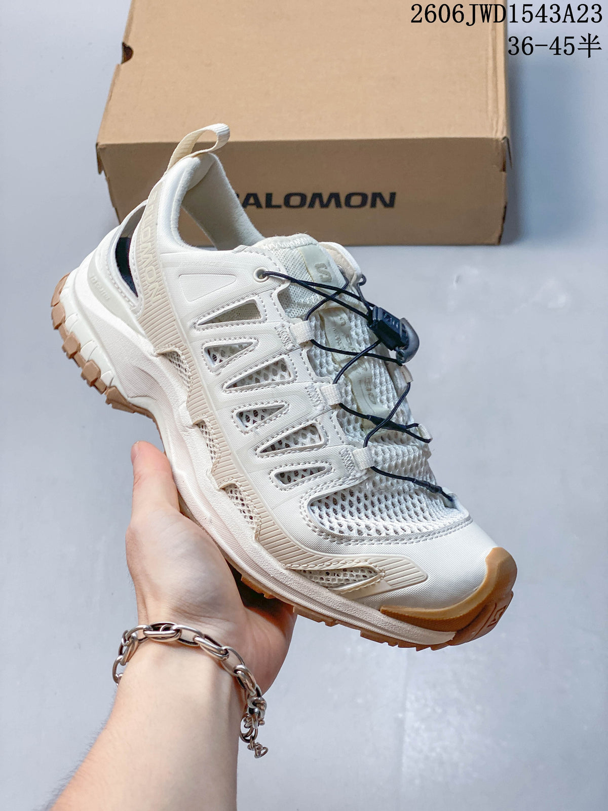 Angled side view of an ivory sneaker with tan outsole details