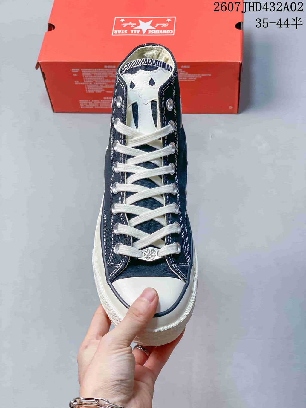 Front view showing white laces, toe cap and decorative tongue patch