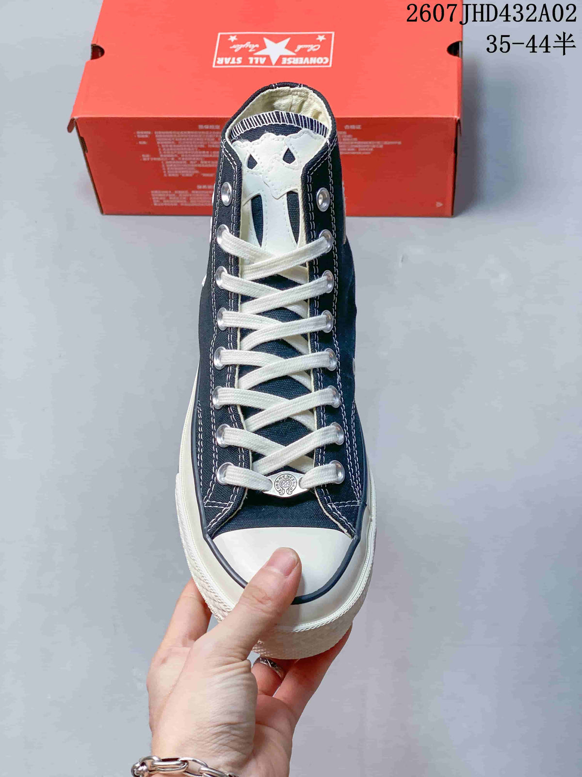 Front view showing white laces, toe cap and decorative tongue patch