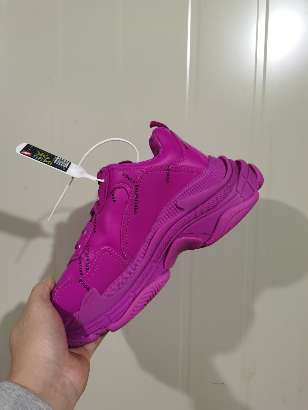 Rear-side view of the vivid purple sneaker showing the chunky layered outsole, heel construction, and black Balenciaga branding.
