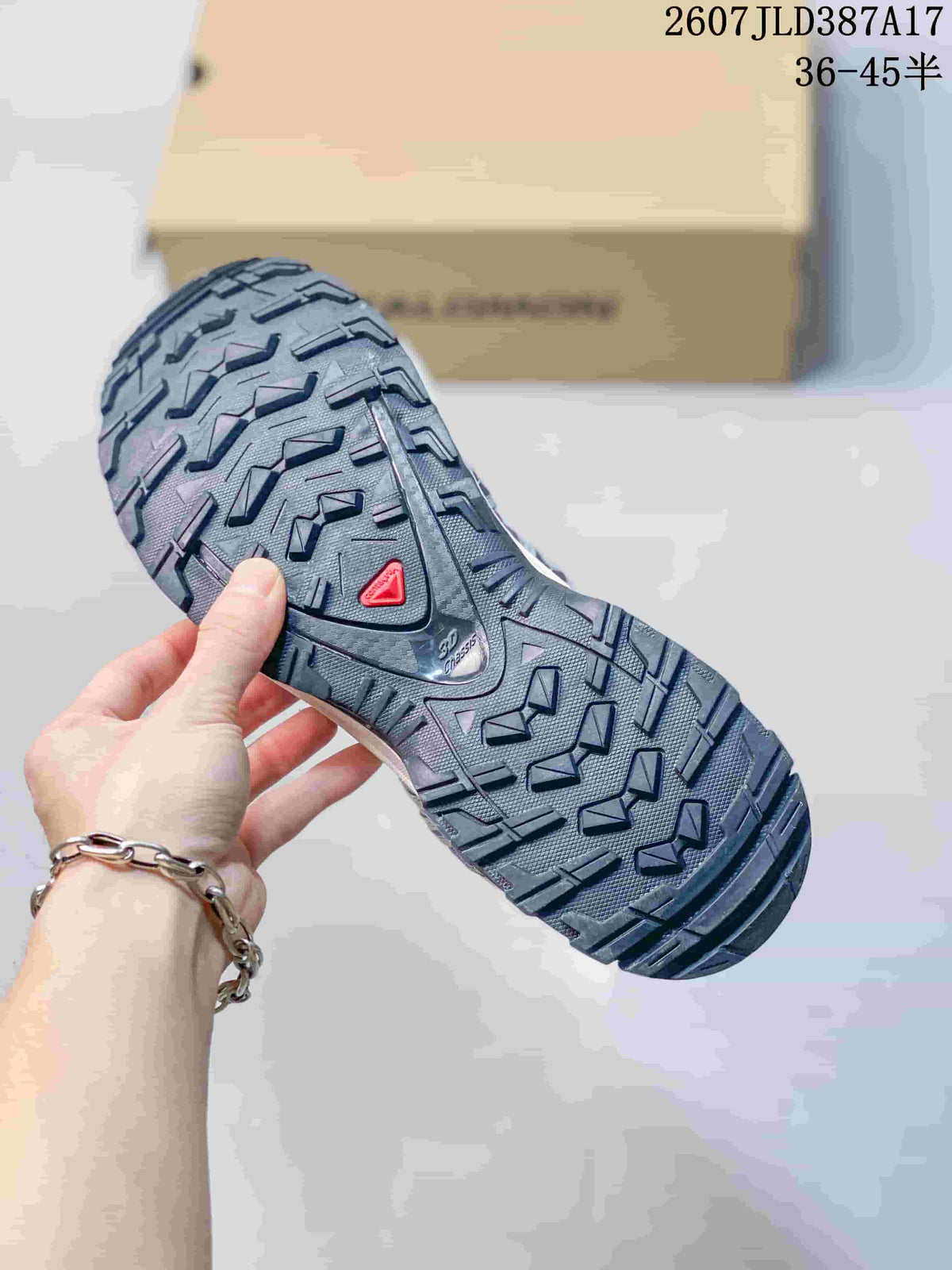 Close view of the Salomon XA PRO 3D outsole showing a black tread pattern with deep directional lugs and a red triangular detail.