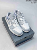 Pair of light grey and white Jordan low-top sneakers displayed on a Jordan shoebox.