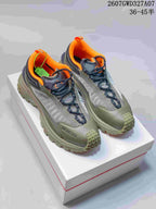 Pair of olive, orange and black Moncler sneakers displayed on a shoebox; style code 2607GWD327A07 and size range 36–45 are visible.