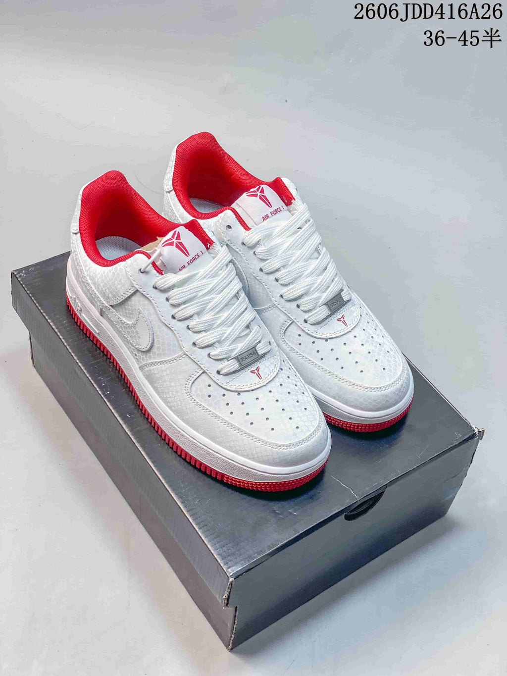 White patterned low-top sneakers with red accents
