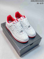 White patterned low-top sneakers with red accents