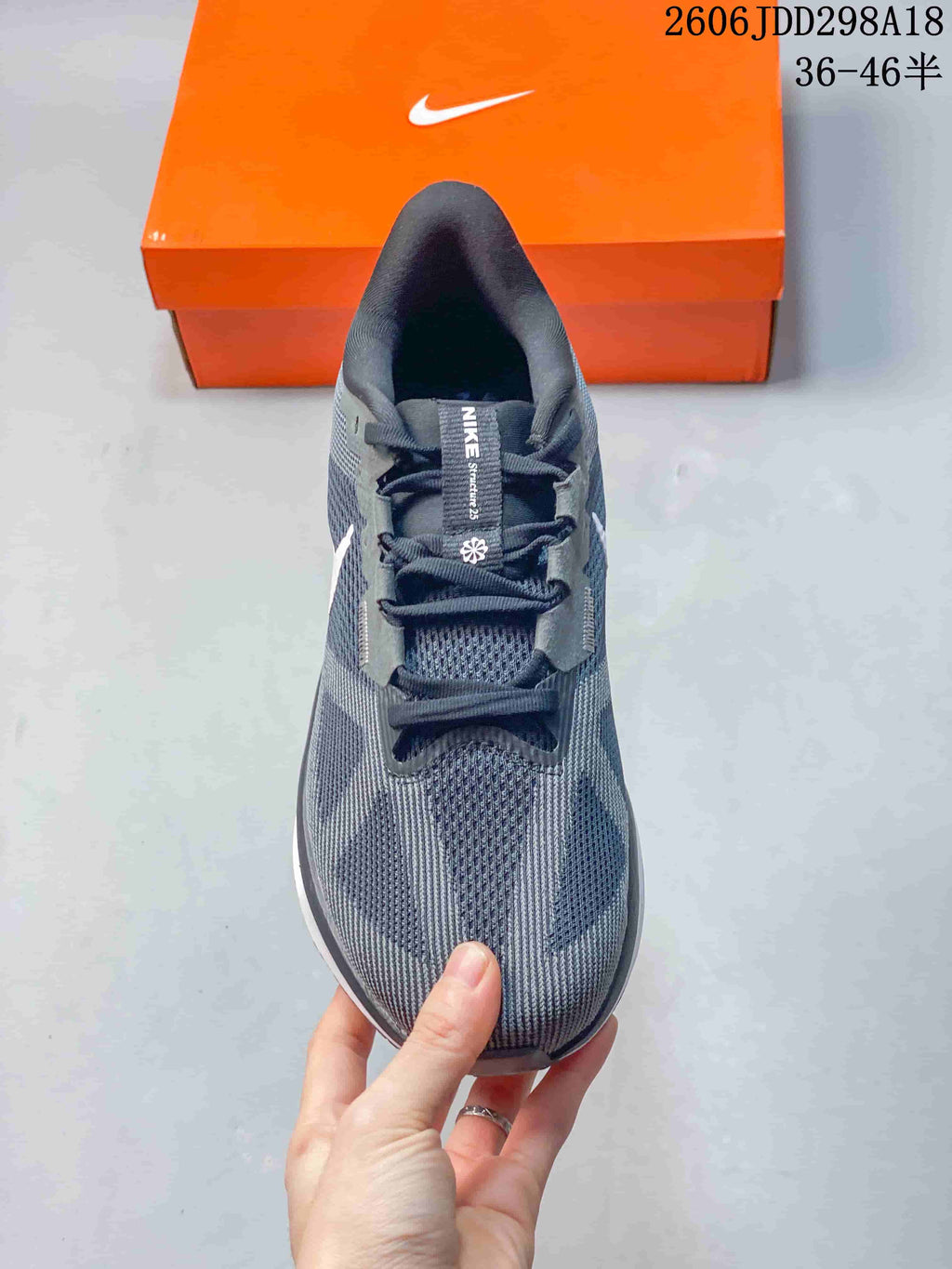 Top view of the gray Nike sneaker showing the mesh toe box, layered panels, and lace system.