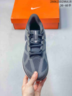 Top view of the gray Nike sneaker showing the mesh toe box, layered panels, and lace system.