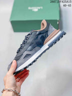 Side profile of a gray Lacoste sneaker showing the layered upper, raised heel section, and textured outsole.