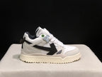 Close side view highlighting the white upper, black arrow detail, padded collar, and textured outsole.
