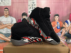 Pair of black Jordan 23 high-top sneakers showing the graphic side panels and gray soles.