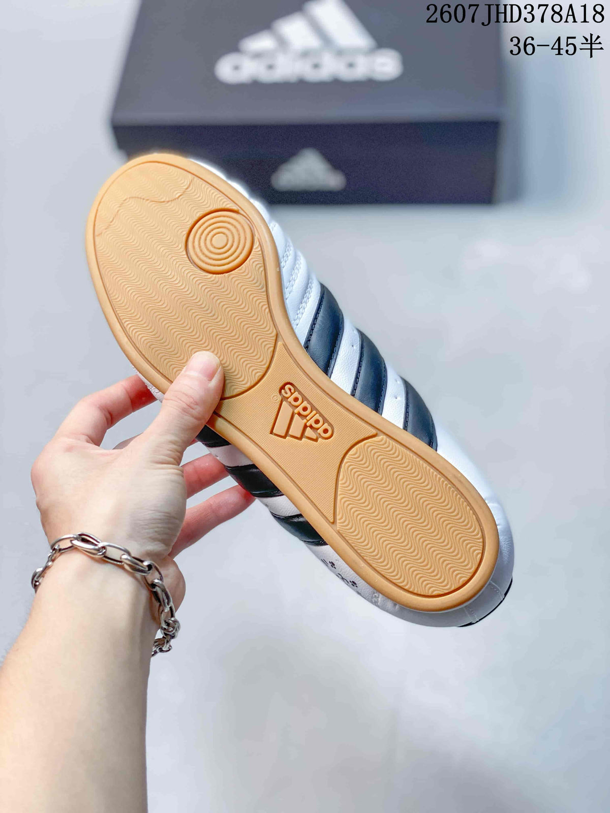 Close view of the gum-colored outsole showing its textured tread and circular pivot detail.