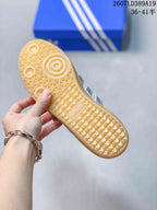 Close-up of the gum-colored outsole showing its textured geometric tread pattern.