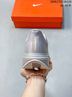 Rear view of the silver-gray Nike Pegasus Plus shoe.