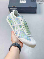 Angled side view of the floral low-top sneaker with white overlays and pale green laces.