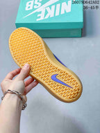 Close-up of the gum-colored outsole with patterned tread and a purple logo